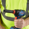 Bosch GDX18V-1800 Freak 18V Cordless Brushless 1/4 inch & 1/2 inch Two-In-One Bit/Socket Impact Driver (Tool Only) showing in workers hand with socket installed on the impact wrench anvil (Socket sold separately)
