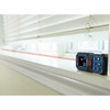Bosch GLM165-22 BLAZE 165 feet Laser Measure showing in use measuring the opening of a window Bosch GLM165-22 BLAZE 165 feet Laser Measure showing in use measuring the opening of a window