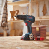 Bosch GXL18V-240B22 2-Tool 1/2 inch Hammer Drill/Driver & Two-In-One Bit/Socket Impact Driver/Wrench Combo Kit showing drill sitting on a work bench with the battery attached