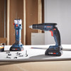 Bosch GXL18V-291B25 18V 2-Tool Cordless Brushless 1/4 inch Hex Screwgun  and Cut-Out Tool Drywall Combo Kit showing tools resting on a job site work work bench between uses