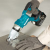Makita DJS200Z 18V LXT Cordless Brushless 14 Gauge Straight Shears (Tool Only) showing in use cutting through sheet metal Makita DJS200Z 18V LXT Cordless Brushless 14 Gauge Straight Shears (Tool Only) showing in use cutting through sheet metal
