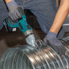 Makita DJS200Z 18V LXT Cordless Brushless 14 Gauge Straight Shears (Tool Only) showing in use cutting through round ducting pipe