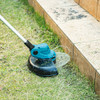 Makita DUR193Z 18V LXT Cordless 10-1/4 inch Line Trimmer (Tool Only) showing in use cutting grass allow wooden boarder Makita DUR193Z 18V LXT Cordless 10-1/4 inch Line Trimmer (Tool Only) showing in use cutting grass allow wooden boarder
