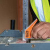 Klein Tools 935CSEL 12-inch Electrician's Combination Square showing in use setting height of table saw blade
