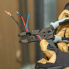 Klein Tools J2159CRTP Hybrid Pliers with Crimper, Fish Tape Puller and Wire Stripper showing in use cutting multiple wires