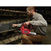 Milwaukee 2967-22GG M18 Cordless 2-Tool 1/2in High Torque Impact Wrench Friction Ring & Grease Gun Combo Kit showing grease gun in use lubricating a excavator track