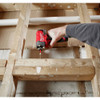 Milwaukee 3453-22 M12 FUEL 1/4 inch Hex Impact Driver Kit showing in use driving a screw through wood studs