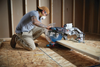 Bosch GCM18V-12GDCN14 PROFACTOR 18V Cordless Surgeon 12in Dual-Bevel Glide Mitre Saw Kit showing in use making a cross cut through dimensional lumber