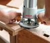 Bosch 1617EVS 2-1/4 HP Electronic Fixed-Base Router trimming an edge