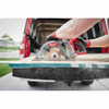 Milwaukee 2830-20 M18 FUEL Cordless 7-1/4 inch Rear Handle Circular Saw (Tool Only) showing cutting plywood on truck tailgate