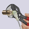 Knipex 8601180SBA 7-1/4 inch Adjustable Wrench Pliers Black showing in use tightening of a brass fitting Knipex 8601180SBA 7-1/4 inch Adjustable Wrench Pliers Black showing in use tightening of a brass fitting