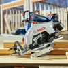Bosch GKS18V-22LN 18V Cordless Brushless 6-1/2 inch Blade-Left Circular Saw (Tool Only) showing saw resting on a stack lumber on a jobsite between cuts