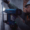 Bosch GNB18V-12N PROFACTOR 18V Cordless Brushless Concrete Nailer (Tool Only) showing in use fastening metal conduit to a concrete wall
