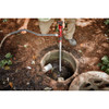 Milwaukee 2579-20 M12 Cordless Stick Transfer Pump (Tool Only) showing in use removing water from drain system