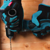 Makita DDA351Z 18V LXT Cordless 3/8 inch Angle Drill (Tool Only) showing in use driving a screw into a wood studs