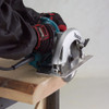 Makita 5007NB 15 Amp 7-1/4 inch Circular Saw showing in use cutting through dimensional lumber Makita 5007NB 15 Amp 7-1/4 inch Circular Saw showing in use cutting through dimensional lumber