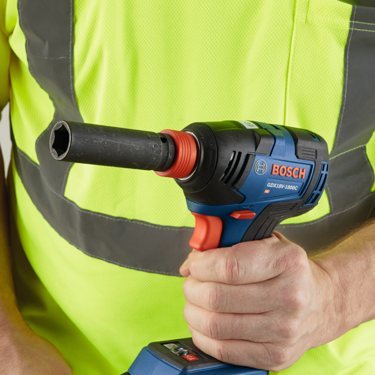 Bosch GDX18V-1800 Freak 18V Cordless Brushless 1/4 inch & 1/2 inch Two-In-One Bit/Socket Impact Driver (Tool Only) showing in workers hand with socket installed on the impact wrench anvil (Socket sold separately)