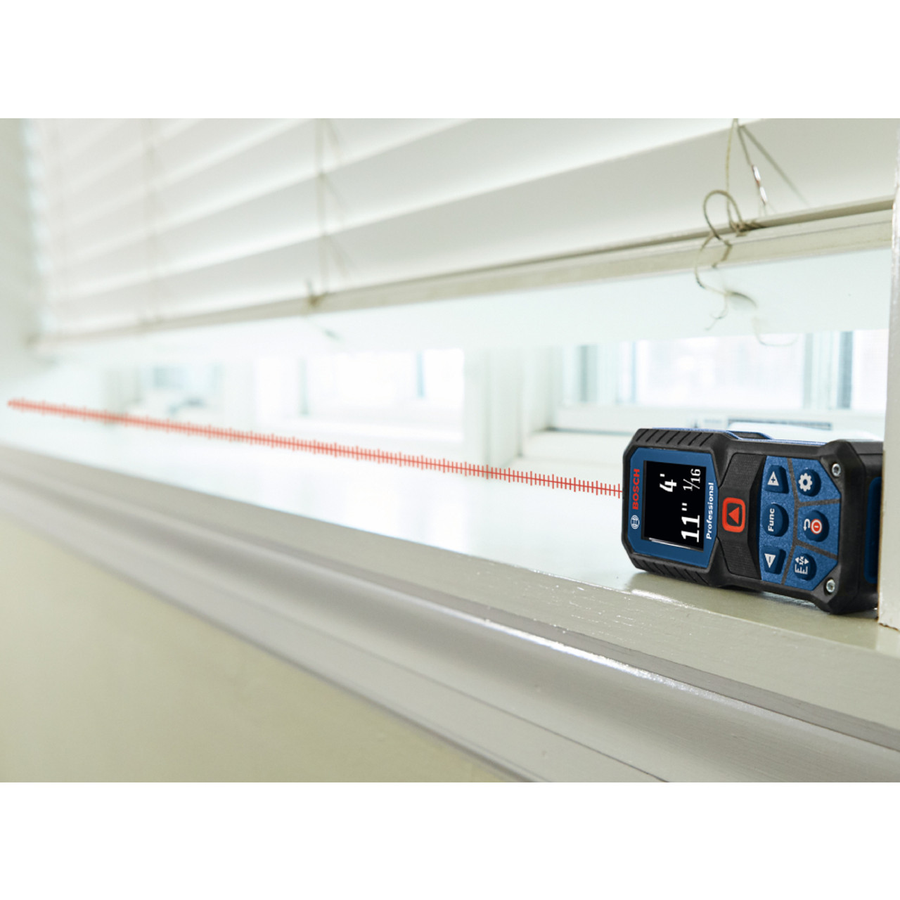 Bosch GLM165-22 BLAZE 165 feet Laser Measure showing in use measuring the opening of a window Bosch GLM165-22 BLAZE 165 feet Laser Measure showing in use measuring the opening of a window