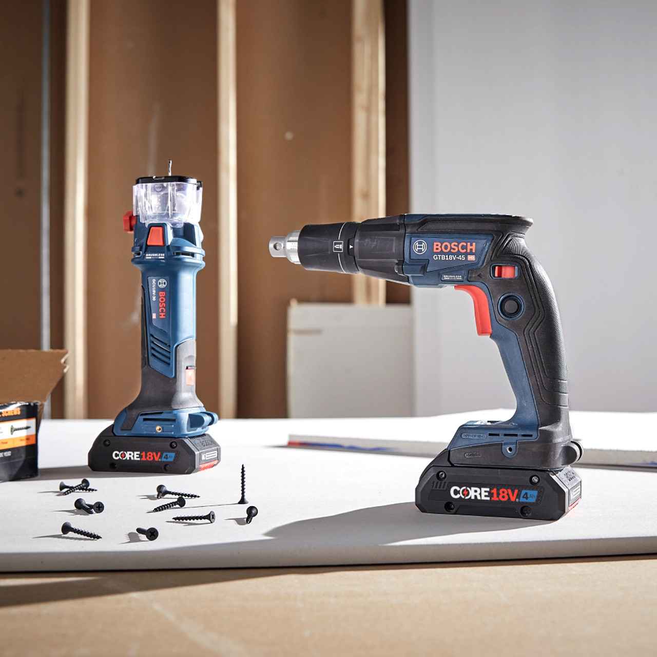 Bosch GXL18V-291B25 18V 2-Tool Cordless Brushless 1/4 inch Hex Screwgun  and Cut-Out Tool Drywall Combo Kit showing tools resting on a job site work work bench between uses