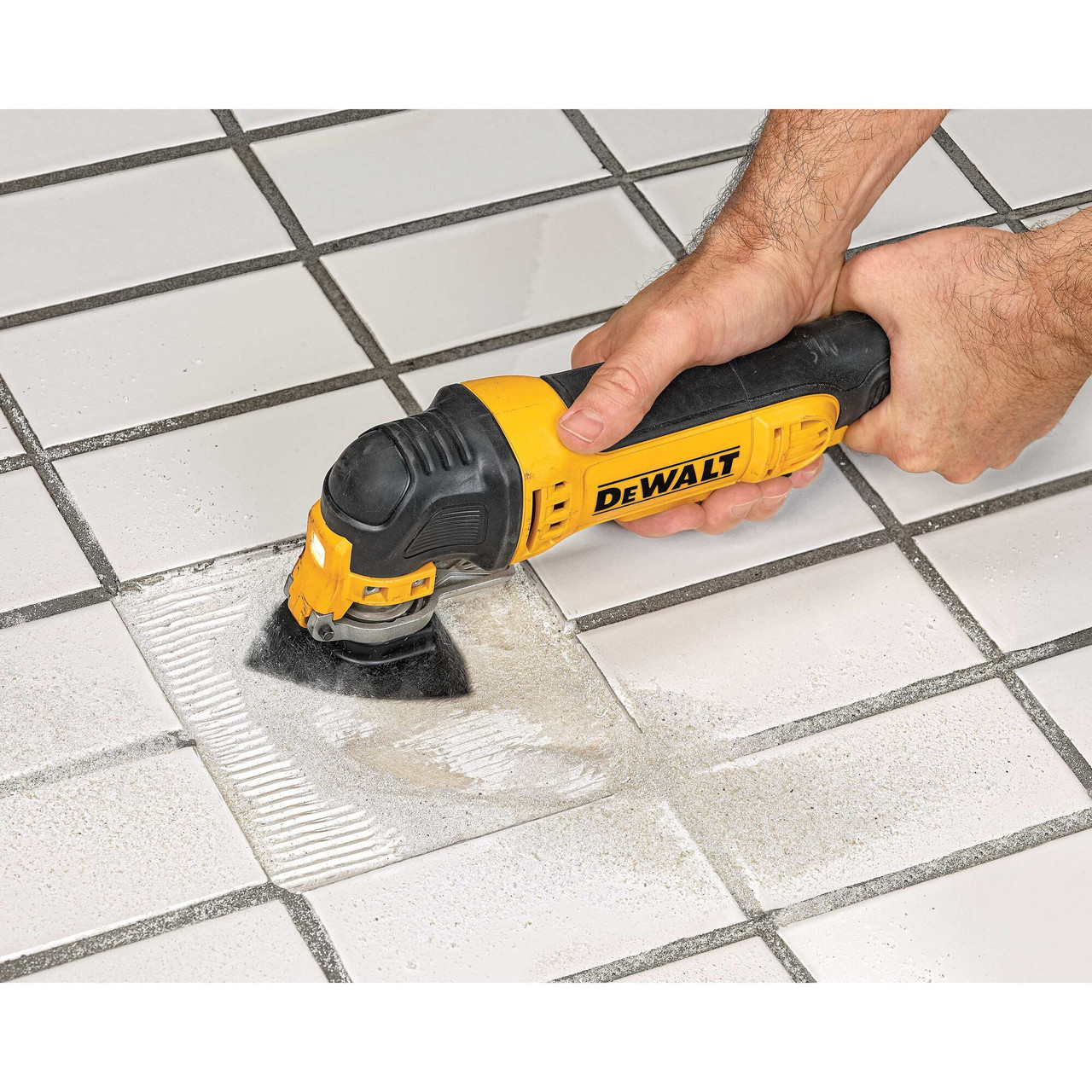 DeWalt DWA4221 3-5/8 inch Tough Grit Carbide Oscillating Rasp Blade showing in use removing mortar from under floor tile that has been removed DeWalt DWA4221 3-5/8 inch Tough Grit Carbide Oscillating Rasp Blade showing in use removing mortar from under floor tile that has been removed