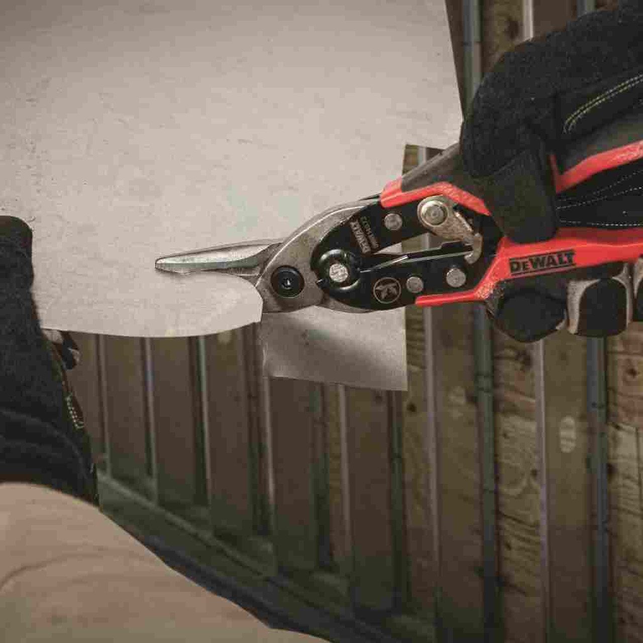 DeWalt DWHT14673 Left Cut Ergo Aviation Snip showing in use cutting pattern in flat metal