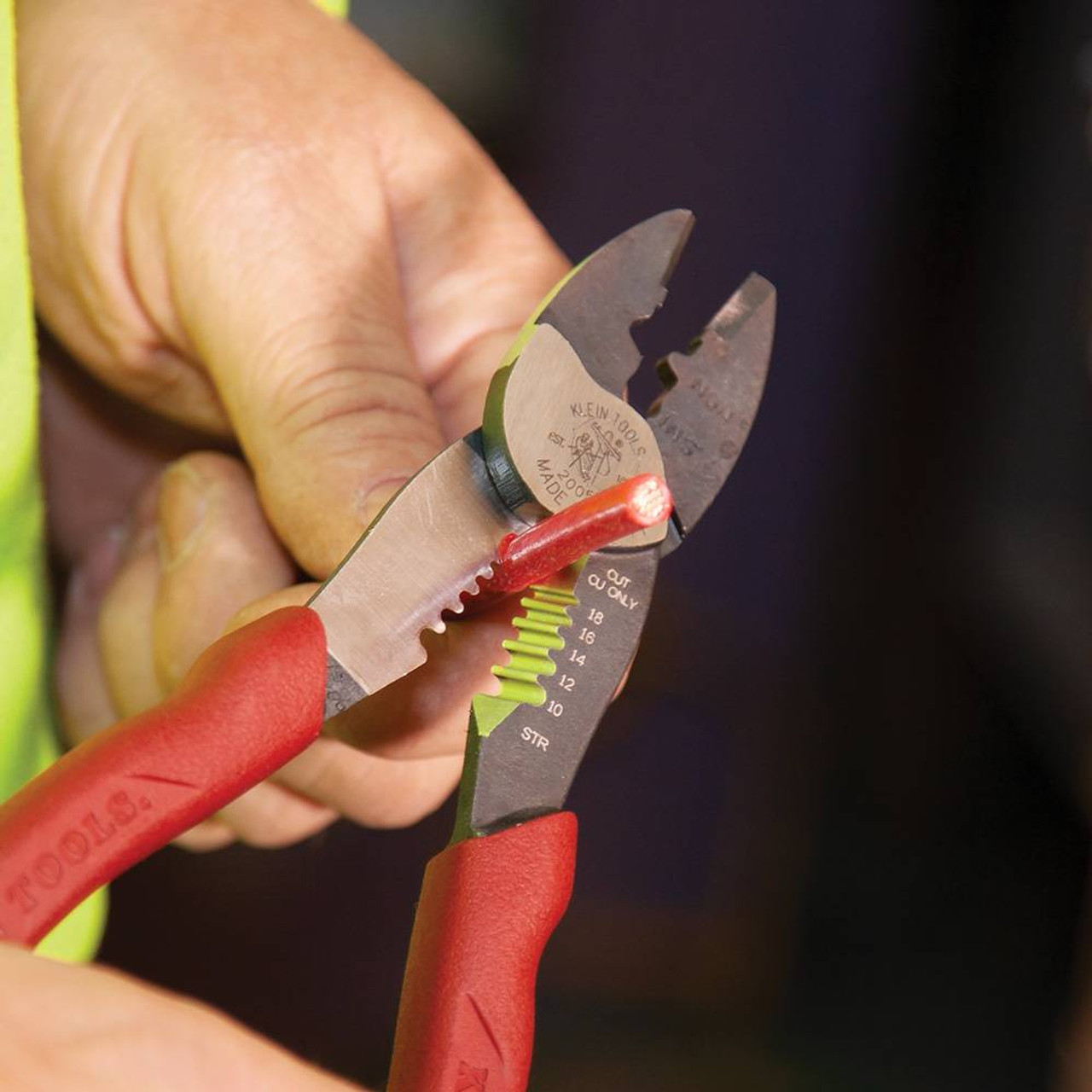 Klein Tools 2005N Forged Steel Wire Crimper, Cutter, Stripper showing in use stripping electrical cable Klein Tools 2005N Forged Steel Wire Crimper, Cutter, Stripper showing in use stripping electrical cable