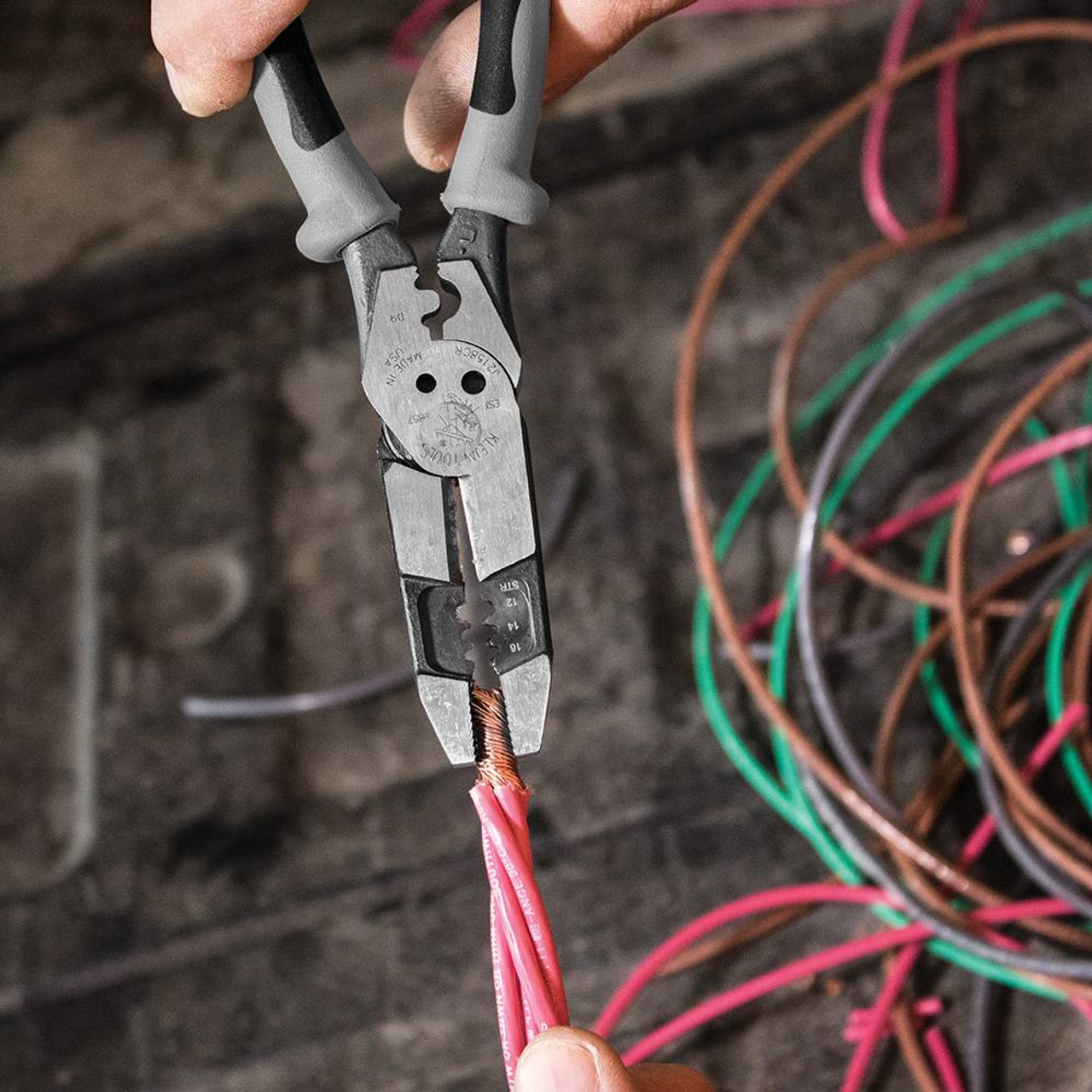 Klein Tools J215-8CR Hybrid Pliers with Crimper and Wire Stripper showing in use twisting wires together