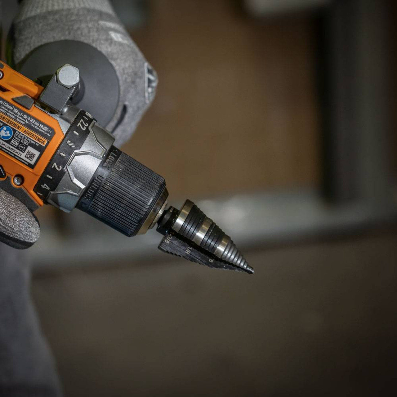 Klein Tools KTSB15 #15 3-Step 7/8 inch to 3/8 inch Double-Fluted High-Speed Step Drill Bit showing bit installed in drill Klein Tools KTSB15 #15 3-Step 7/8 inch to 3/8 inch Double-Fluted High-Speed Step Drill Bit showing bit installed in drill