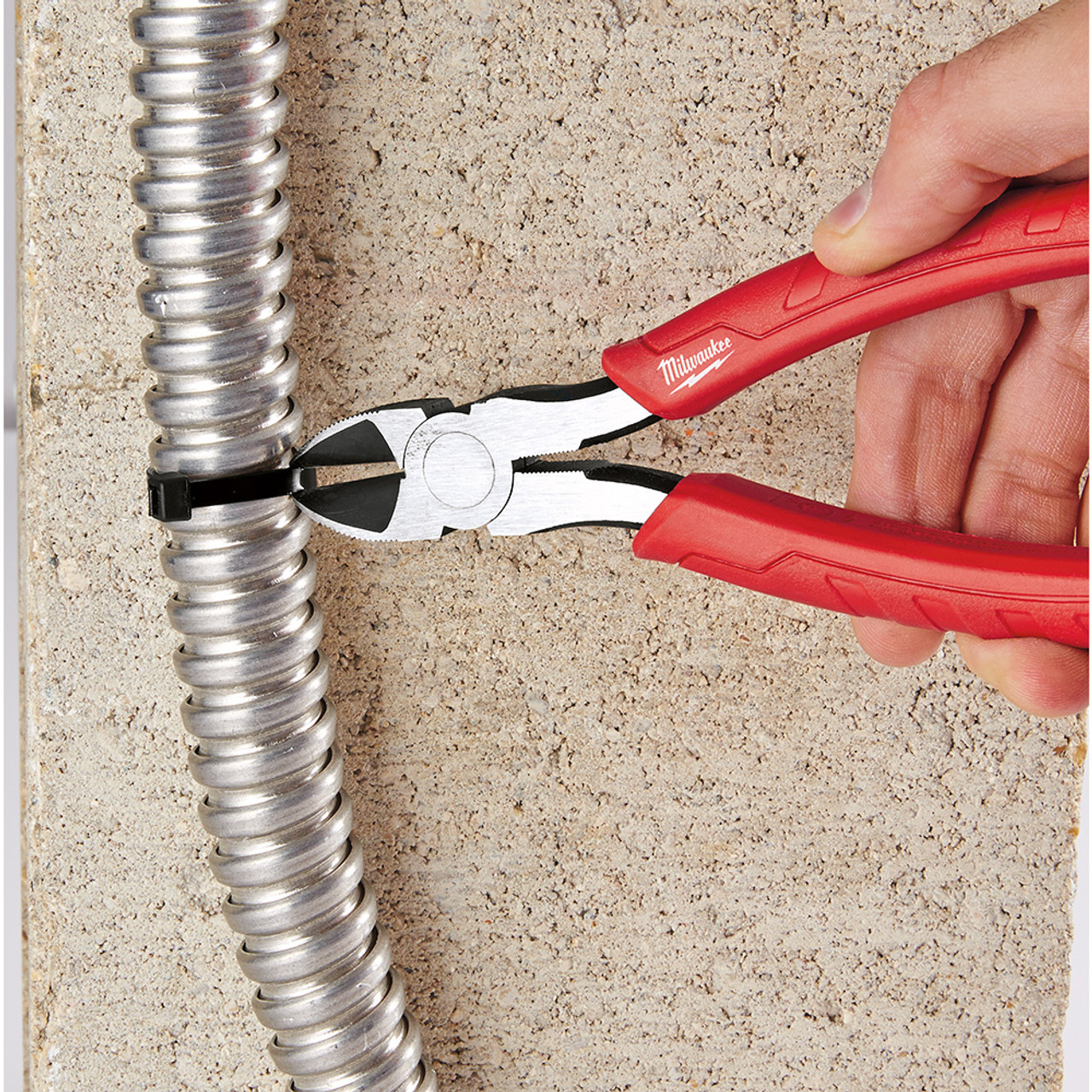 Milwaukee 48-22-6108 8 inch Comfort Grip Diagonal Pliers showing in use cutting zip-tie off of BX cable Milwaukee 48-22-6108 8 inch Comfort Grip Diagonal Pliers showing in use cutting zip-tie off of BX cable