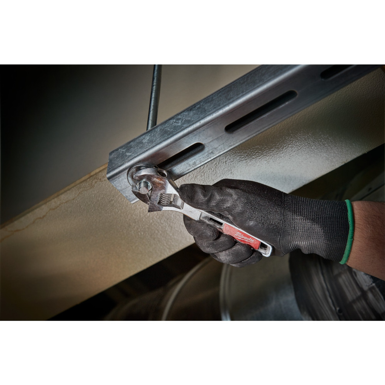 Milwaukee 48-22-7406 6 inch Adjustable Wrench showing in use fastening bolt through bracket into ceiling Milwaukee 48-22-7406 6 inch Adjustable Wrench showing in use fastening bolt through bracket into ceiling
