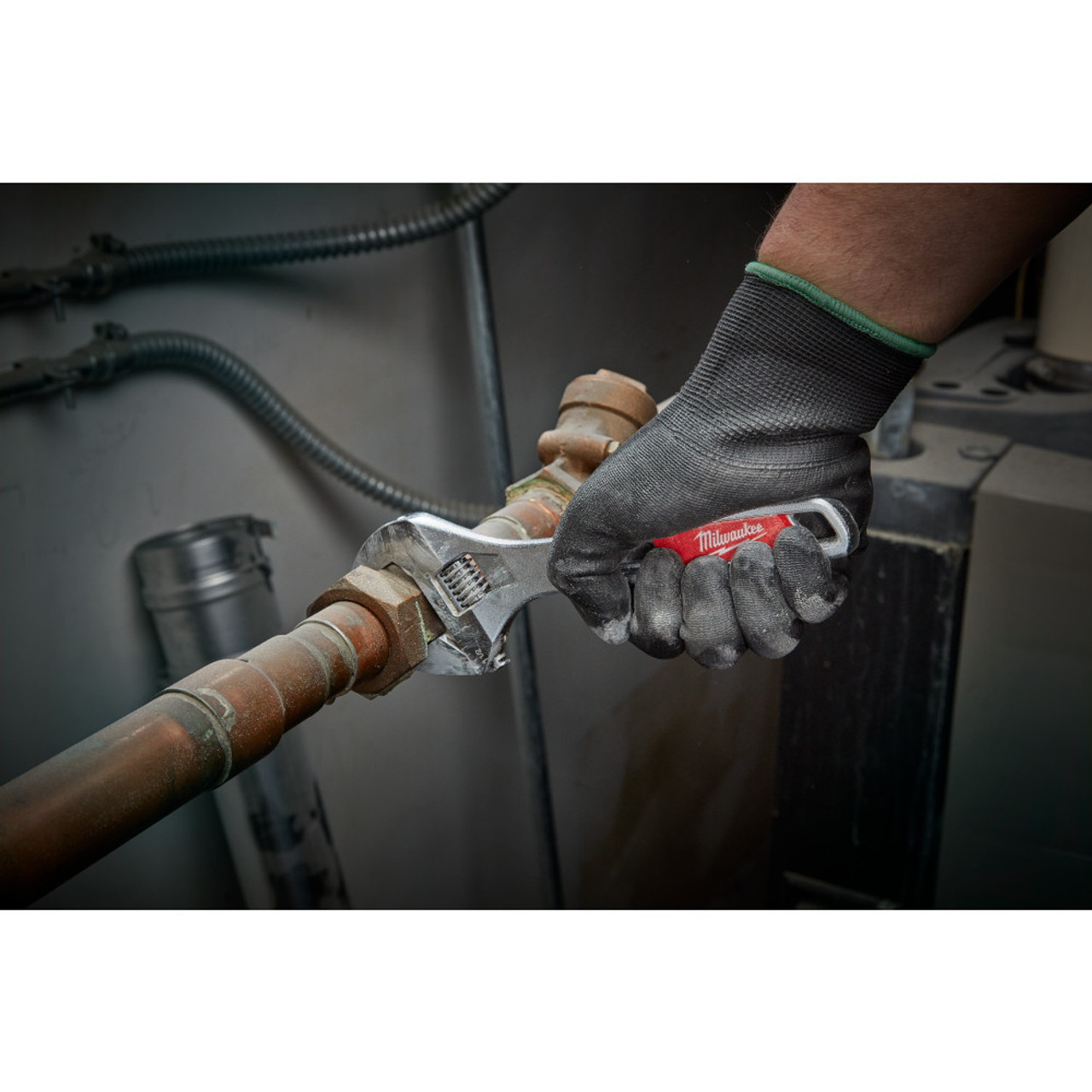 Milwaukee 48-22-7508 8 inch Wide Jaw Adjustable Wrench showing in use fastening metal pipe together Milwaukee 48-22-7508 8 inch Wide Jaw Adjustable Wrench showing in use fastening metal pipe together