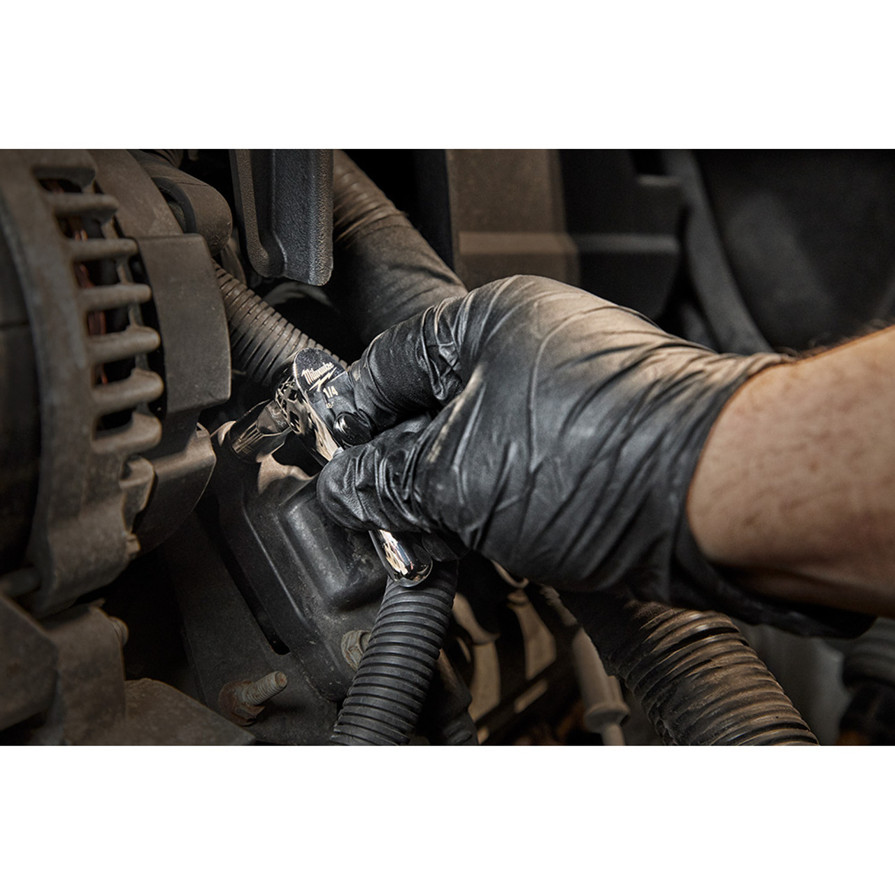 Milwaukee 48-22-9003 1/4-inch Drive 3-inch Stubby Ratchet showing in use fastening bolt in confined space inside motor cavity Milwaukee 48-22-9003 1/4-inch Drive 3-inch Stubby Ratchet showing in use fastening bolt in confined space inside motor cavity