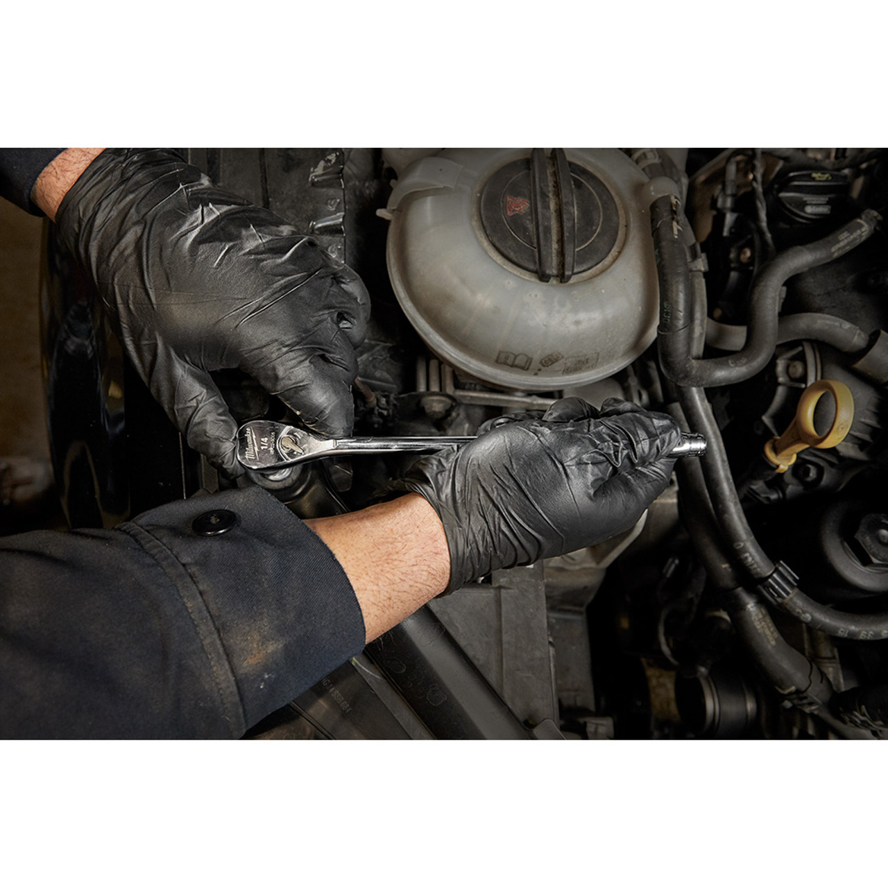 Milwaukee 48-22-9005 1/4-inch Drive 9-inch Extended Ratchet showing in use fastening bolt inside motor cavity Milwaukee 48-22-9005 1/4-inch Drive 9-inch Extended Ratchet showing in use fastening bolt inside motor cavity