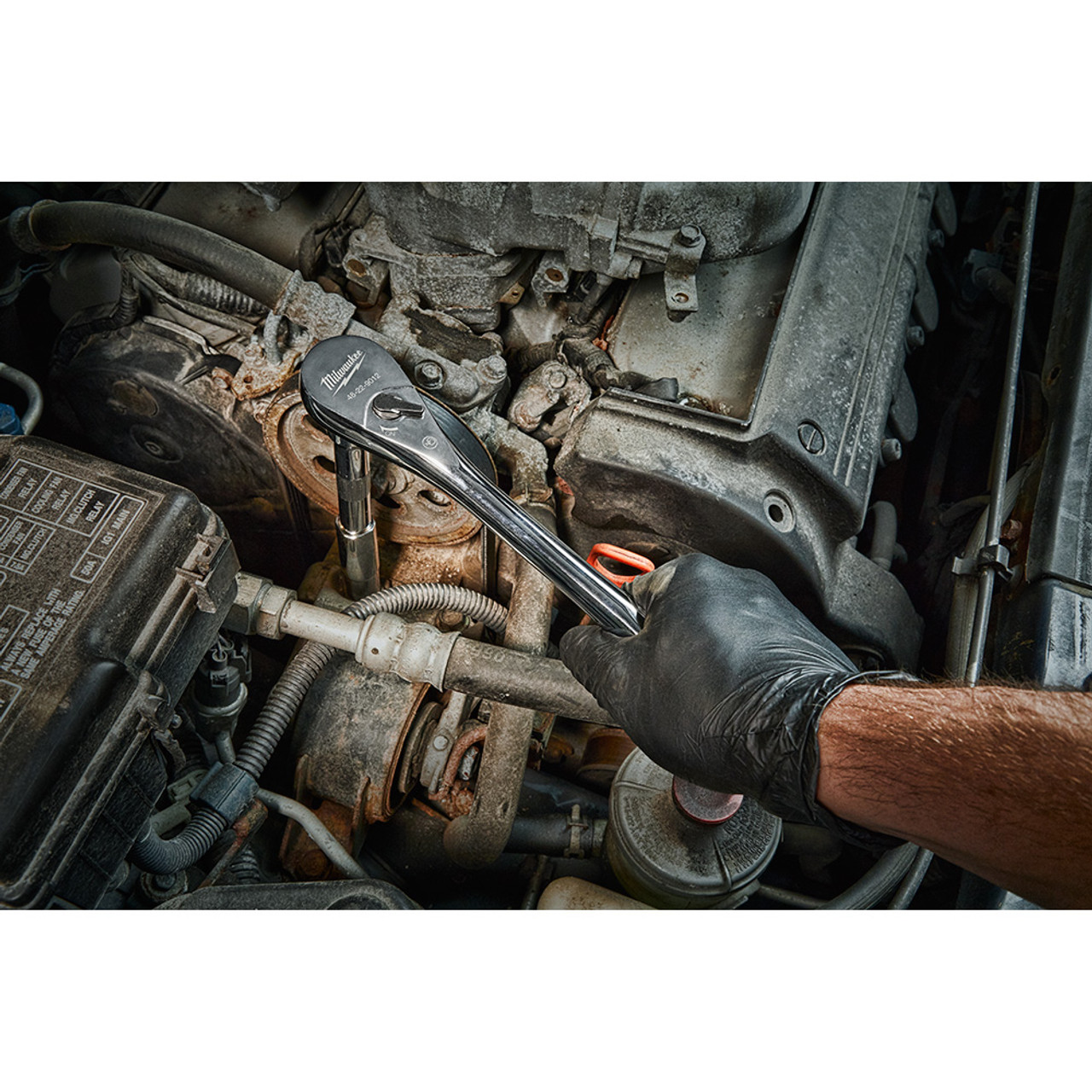 Milwaukee 48-22-9012 1/2-inch Drive Ratchet showing in use fastening bolt inside motor cavity Milwaukee 48-22-9012 1/2-inch Drive Ratchet showing in use fastening bolt inside motor cavity
