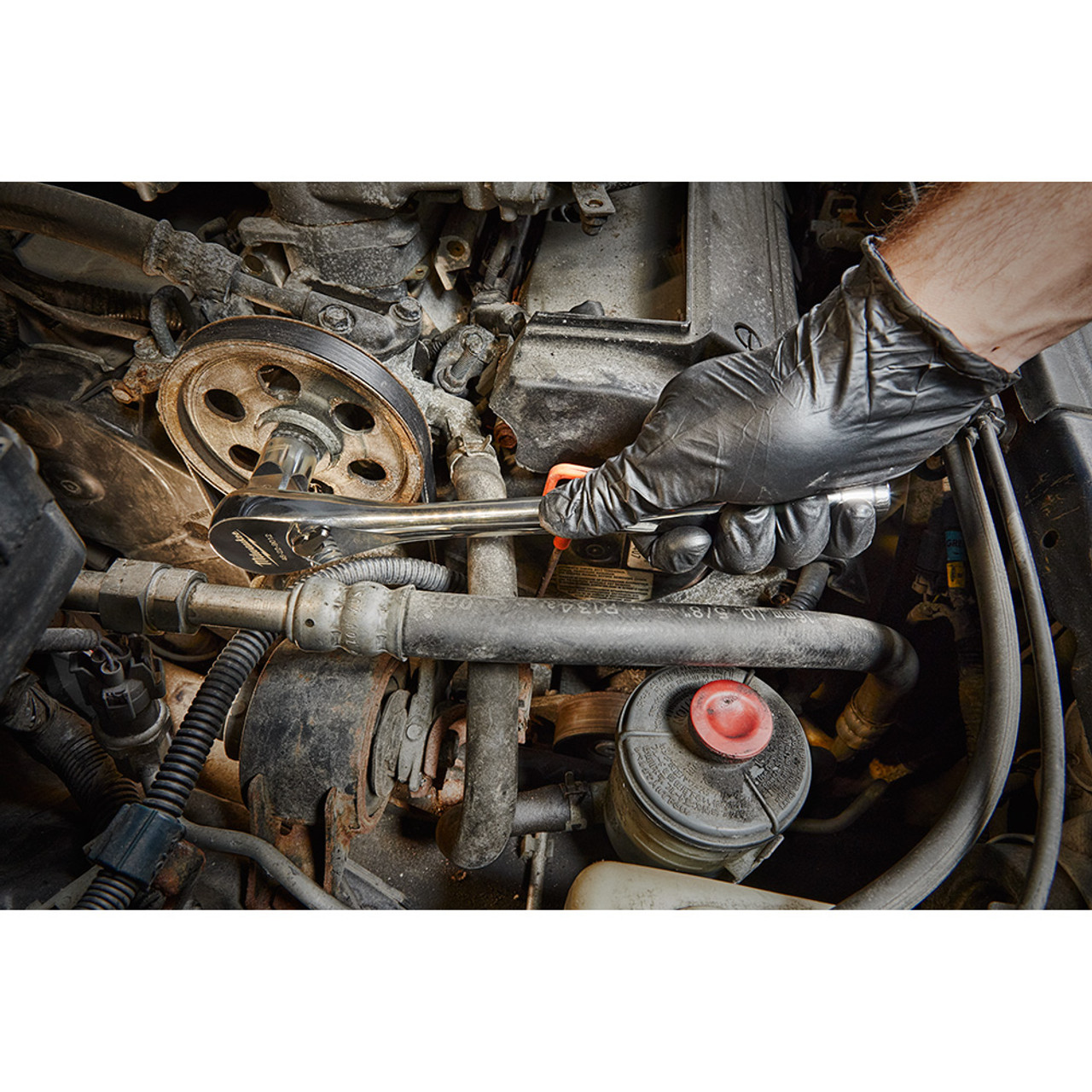 Milwaukee 48-22-9010 47pc Metric & SAE 1/2-inch Drive Ratchet & Socket Set showing in use fastening bolt inside motor cavity Milwaukee 48-22-9010 47pc Metric & SAE 1/2-inch Drive Ratchet & Socket Set showing in use fastening bolt inside motor cavity