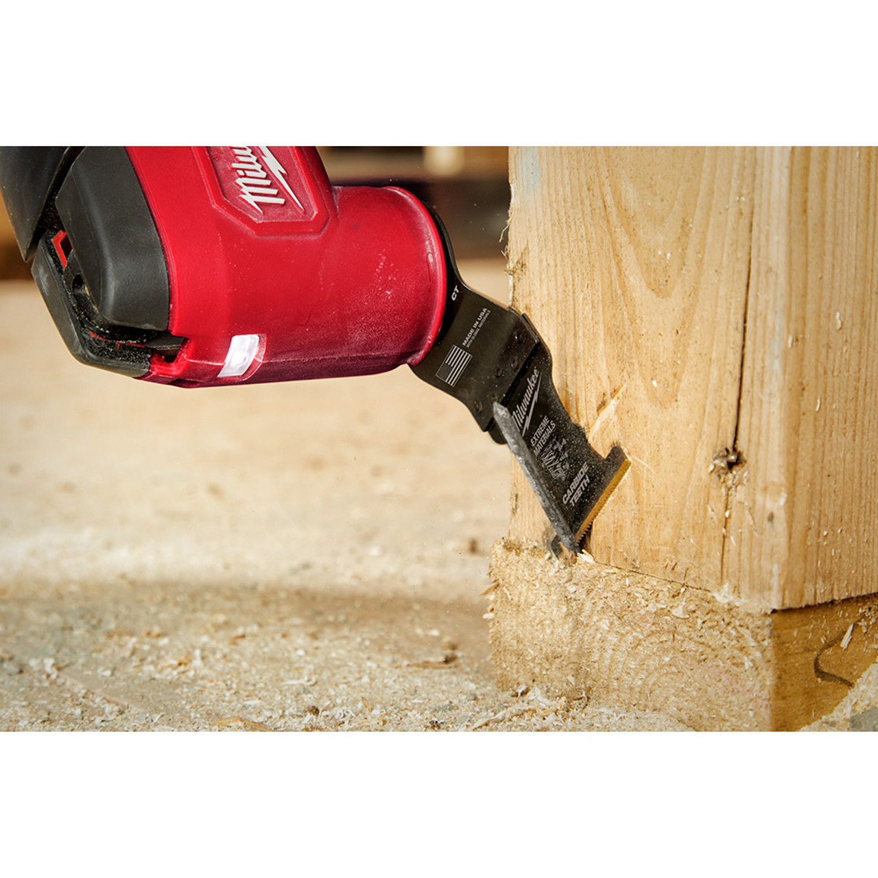 Milwaukee 49-25-1523 OPEN-LOK 1-3/8-inch Universal Fit Titanium Enhanced Carbide Teeth Multi-Material Cutting Multi-Tool Oscillating Blades - 3pk showing in use cutting nail sticking out of a  2 inchX4 inch wood stud Milwaukee 49-25-1523 OPEN-LOK 1-3/8-inch Universal Fit Titanium Enhanced Carbide Teeth Multi-Material Cutting Multi-Tool Oscillating Blades - 3pk showing in use cutting nail sticking out of a  2 inchX4 inch wood stud