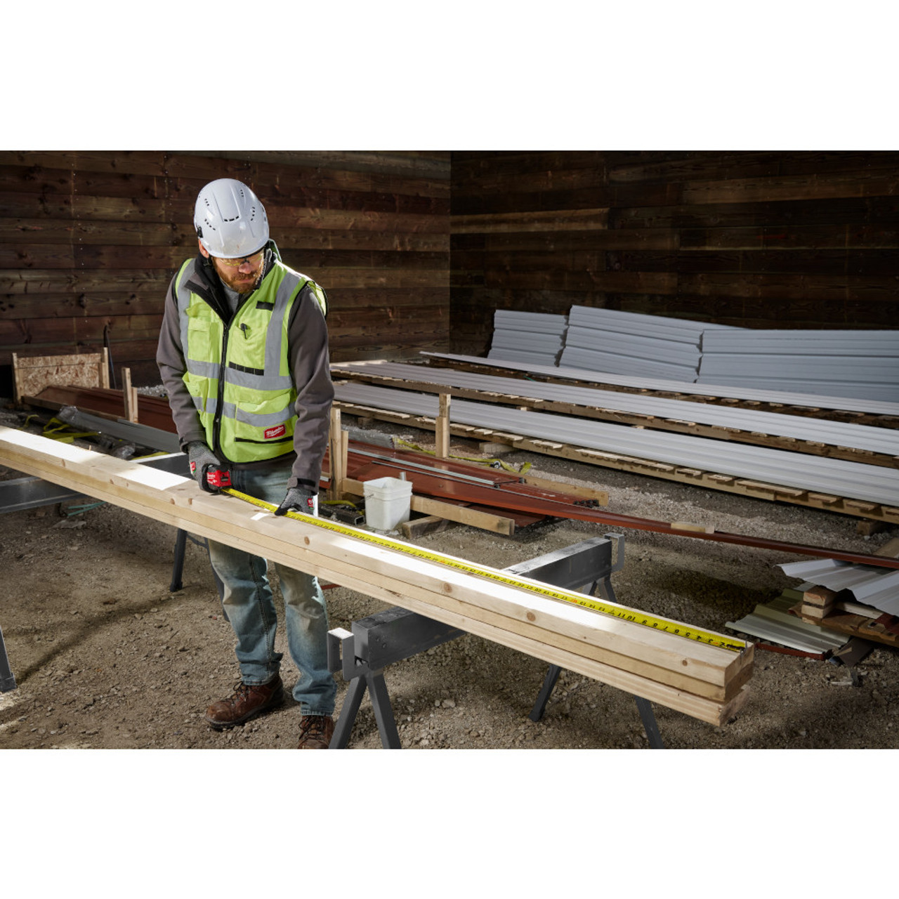 Milwaukee 48-22-1217 16ft/5m Wide Blade Tape Measure showing in action measuring and marking studs Milwaukee 48-22-1217 16ft/5m Wide Blade Tape Measure showing in action measuring and marking studs
