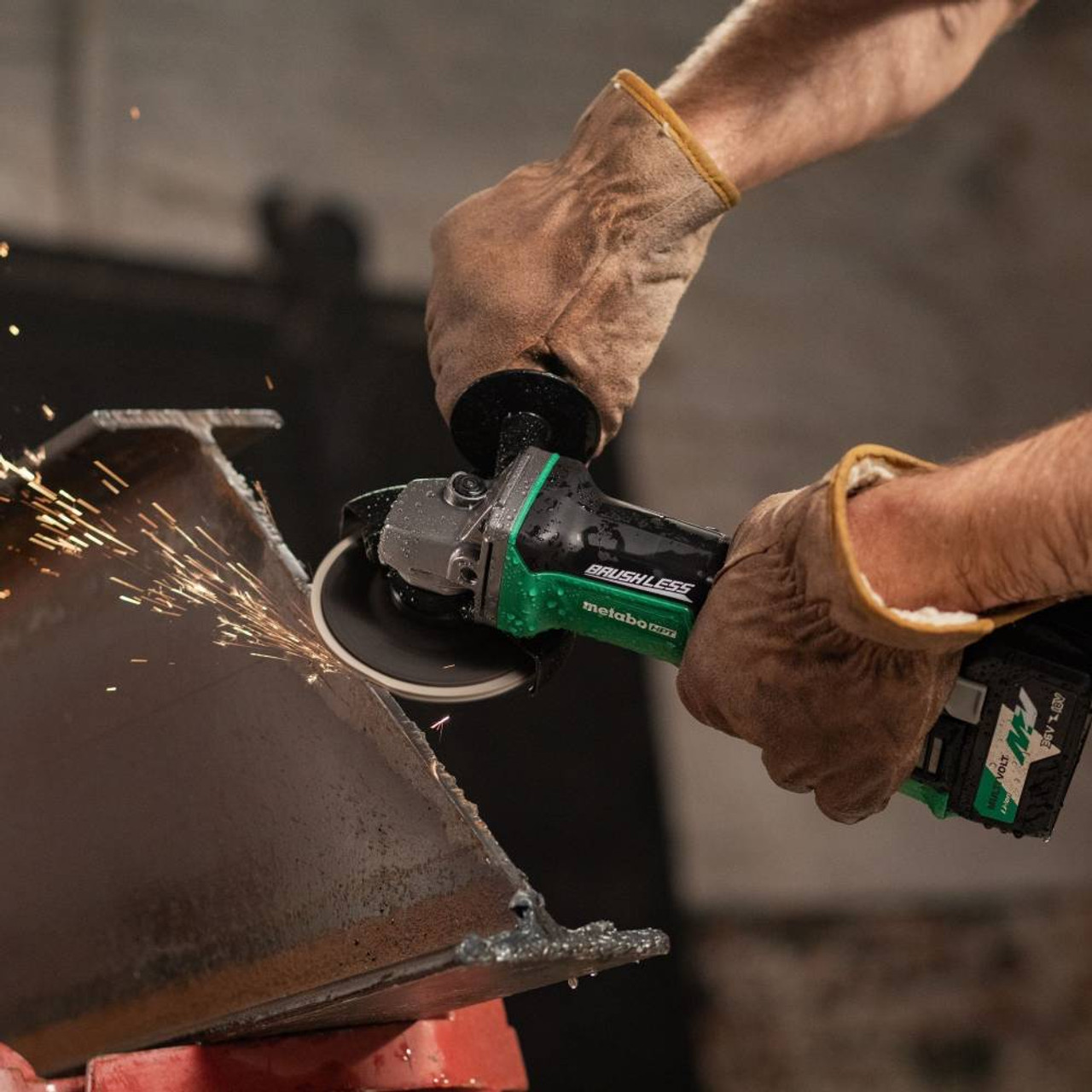 Metabo HPT G18DBALQ4M 18V 4-1/2in Cordless Brushless Angle Grinder (Tool Only) showing in use grinding cut edge of an I-Beam (Battery sold separately) Metabo HPT G18DBALQ4M 18V 4-1/2in Cordless Brushless Angle Grinder (Tool Only) showing in use grinding cut edge of an I-Beam (Battery sold separately)