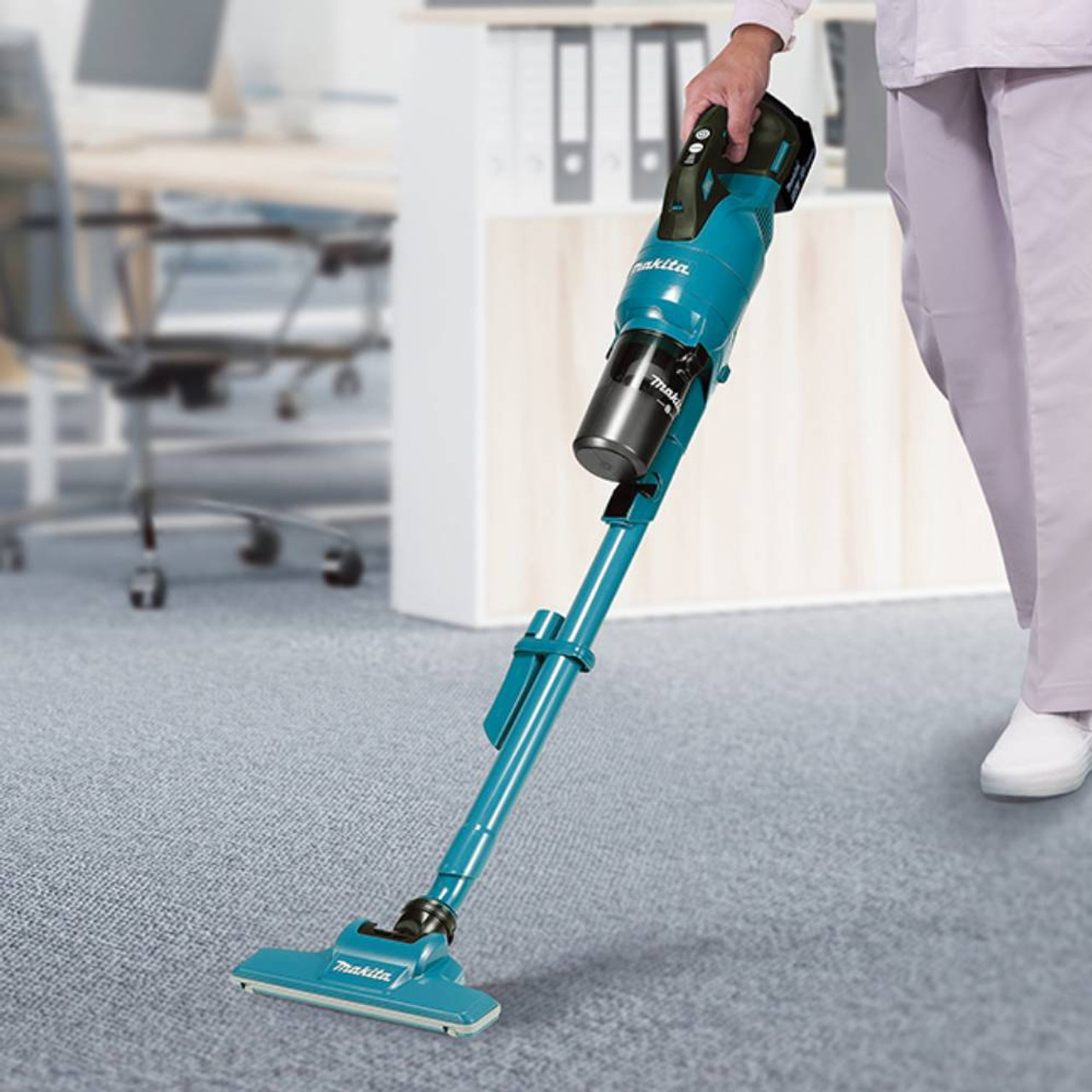 Makita DCL286FZ 18V Brushless 250ml Cyclone Stick Vacuum Cleaner (Tool Only) showing in use vacuuming up carpet Makita DCL286FZ 18V Brushless 250ml Cyclone Stick Vacuum Cleaner (Tool Only) showing in use vacuuming up carpet