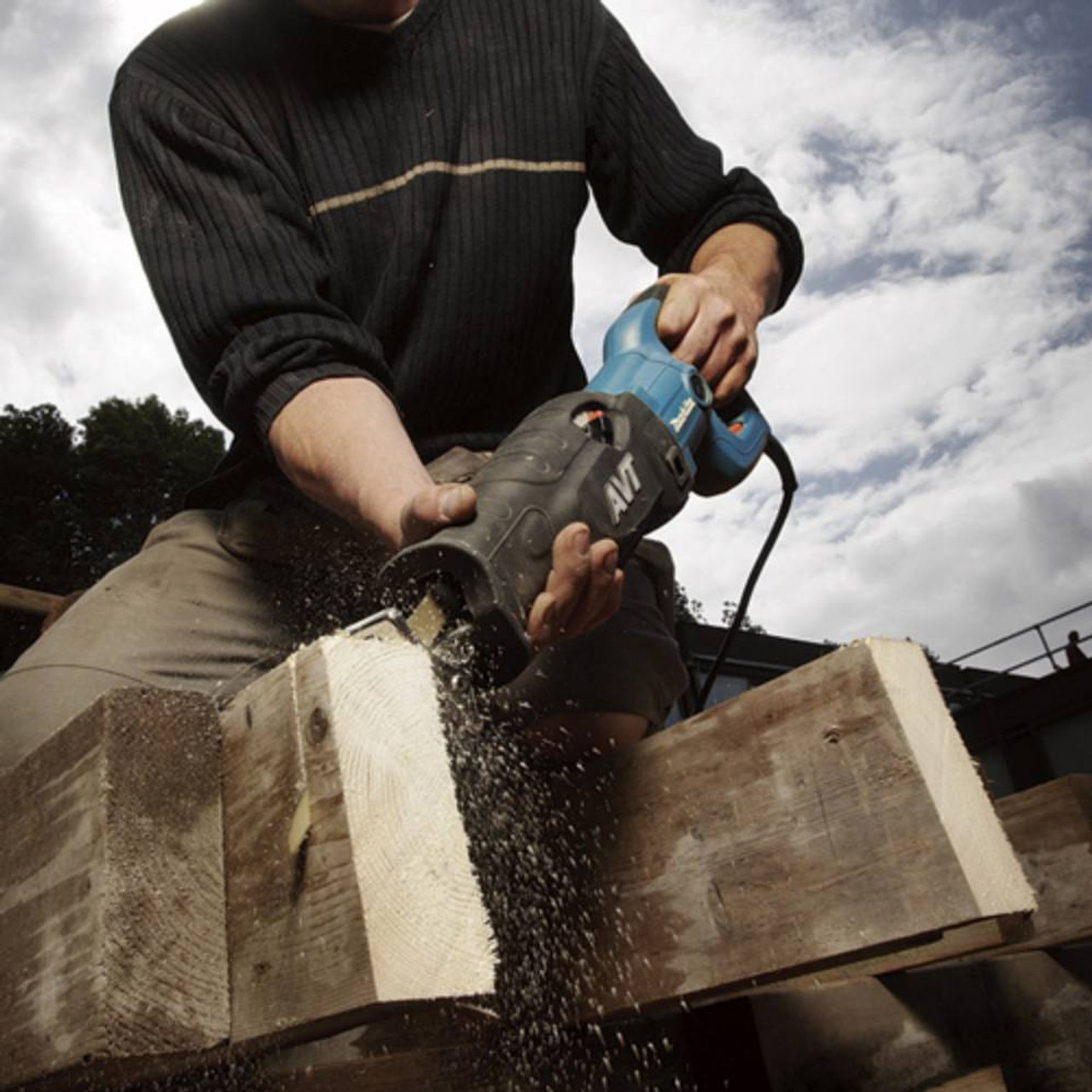 Makita JR3070CT 15 Amp 1/4in Orbital Action Reciprocating Saw showing in use cutting through wood rafter Makita JR3070CT 15 Amp 1/4in Orbital Action Reciprocating Saw showing in use cutting through wood rafter