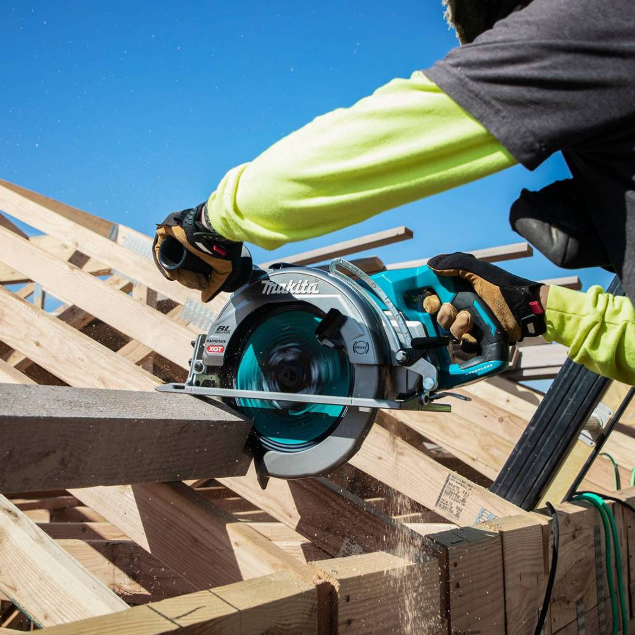 Makita RS002GM101 40V XGT Brushless 10-1/4in Circular Saw Kit showing in use cutting a beam on a roof Makita RS002GM101 40V XGT Brushless 10-1/4in Circular Saw Kit showing in use cutting a beam on a roof