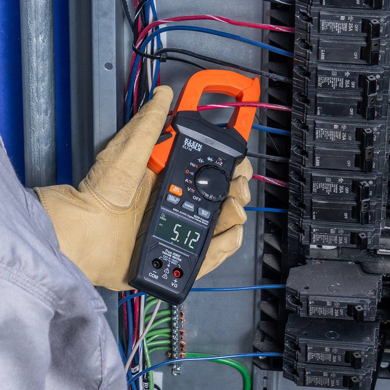 Klein Tools CL710 600 Amp AC/DC Auto-Ranging Digital Pro Clamp Meter showing in use  measuring electrical elements with clamp