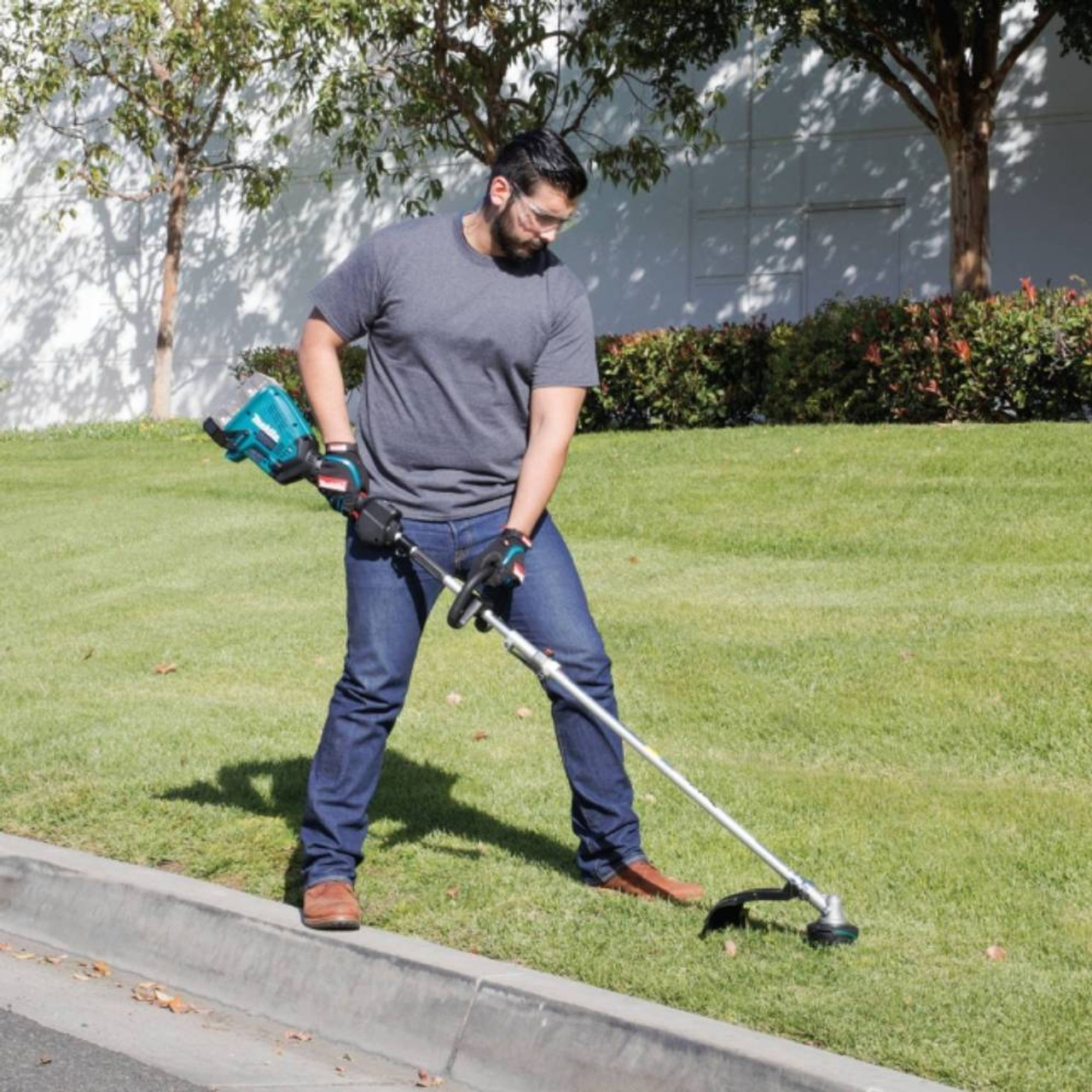 Makita DUX60ZM5X 18Vx2 LXT Brushless Split Shaft Power Head Unit with 16-1/2 inch Line Trimmer Attachment (Tool Only) showing in use cleaning up areas of a lawn (Battery sold separately) Makita DUX60ZM5X 18Vx2 LXT Brushless Split Shaft Power Head Unit with 16-1/2 inch Line Trimmer Attachment (Tool Only) showing in use cleaning up areas of a lawn (Battery sold separately)