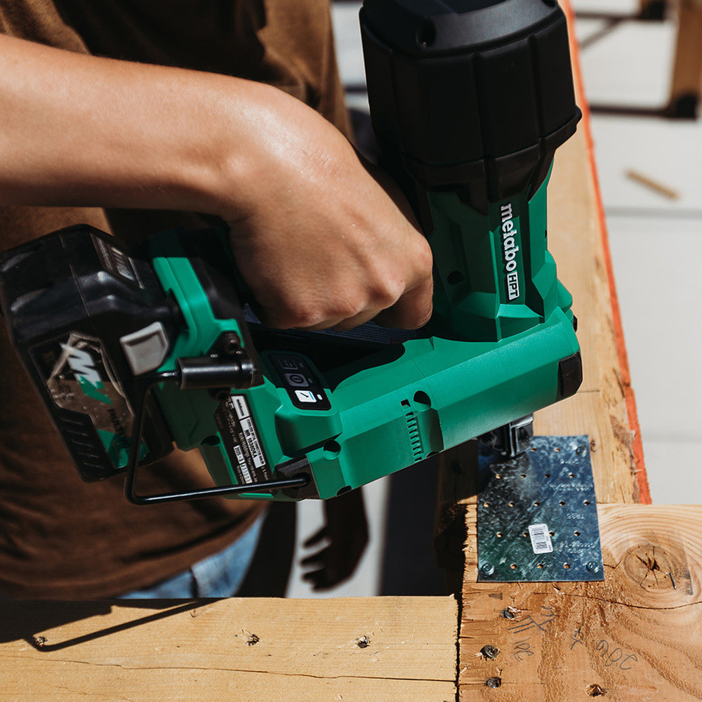 Metabo HPT NR1838DKAM 18V MultiVolt Cordless Brushless 1-1/2in Metal Connector Nailer Kit showing in use nailing a connector plate between two wood joists