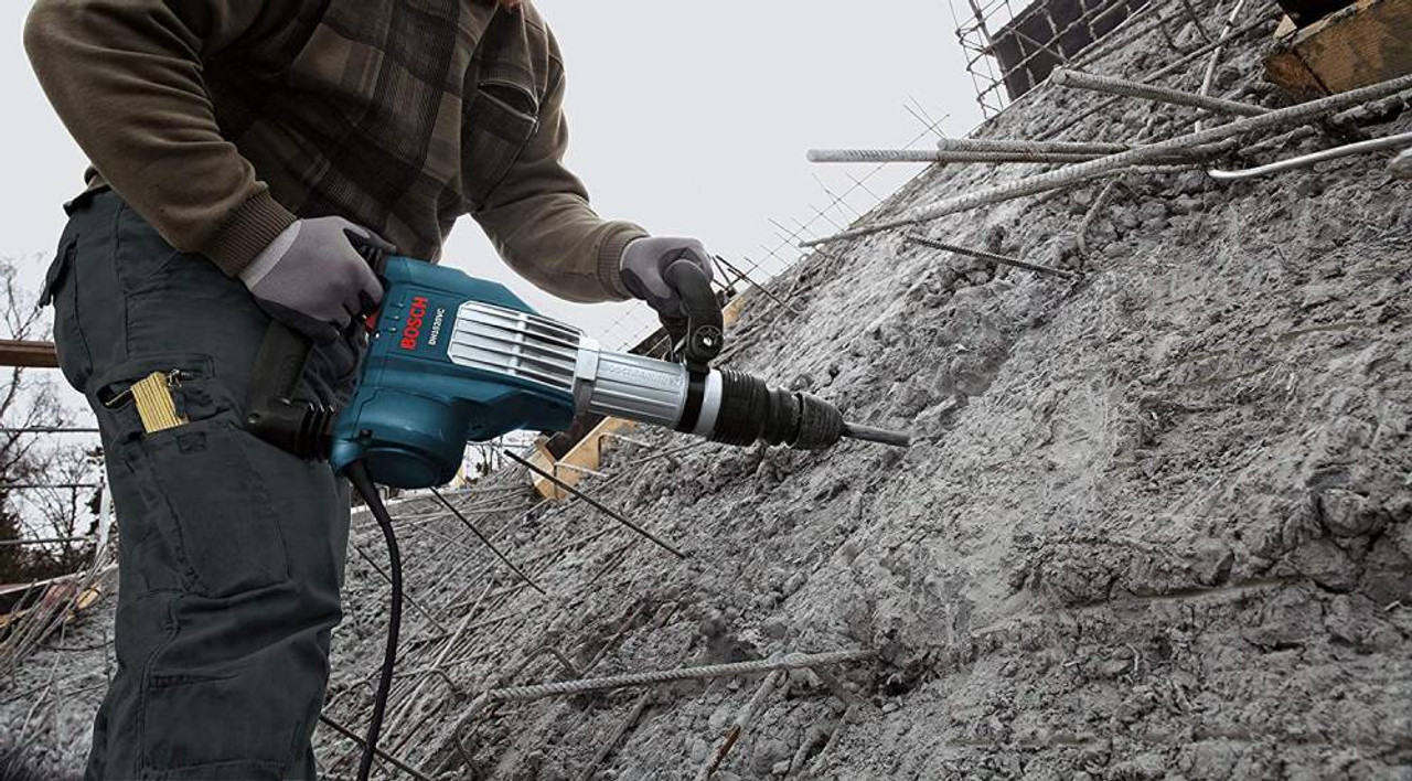 Bosch DH1020VC 15 Amp SDS-Max Demolition Hammer wrecking a cement wall Bosch DH1020VC 15 Amp SDS-Max Demolition Hammer wrecking a cement wall