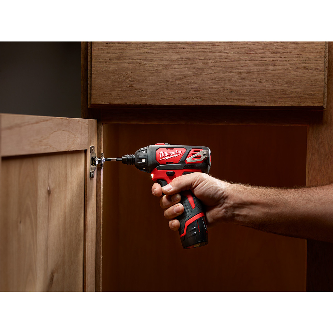 Milwaukee 2401-20 M12 1/4 inch Hex Screwdriver installing a hinge (battery and bits sold separately) Milwaukee 2401-20 M12 1/4 inch Hex Screwdriver installing a hinge (battery and bits sold separately)
