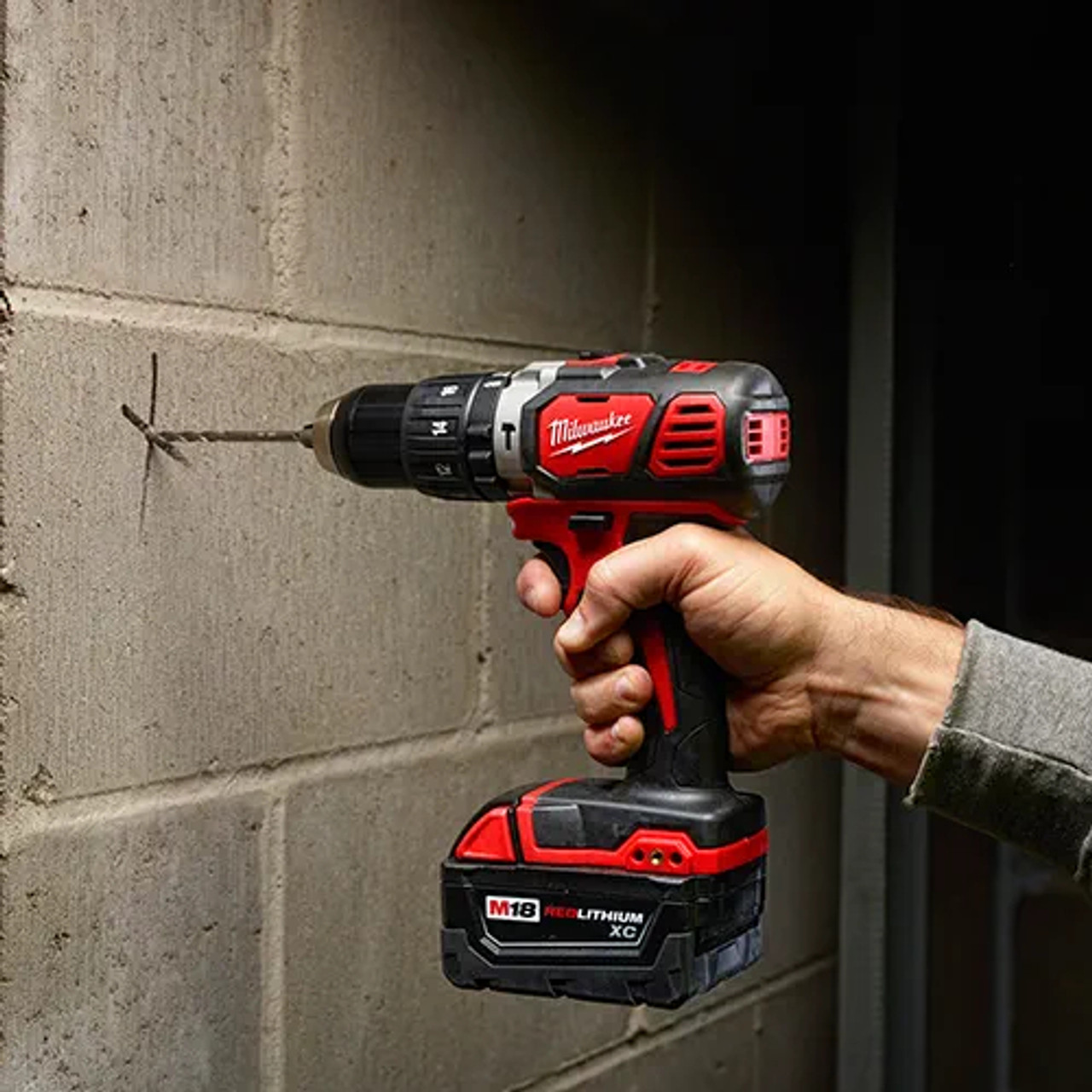 Milwaukee 2607-20 M18 Compact 1/2-Inch Hammer Drill/Driver drilling into concrete (battery sold separately) Milwaukee 2607-20 M18 Compact 1/2-Inch Hammer Drill/Driver drilling into concrete (battery sold separately)