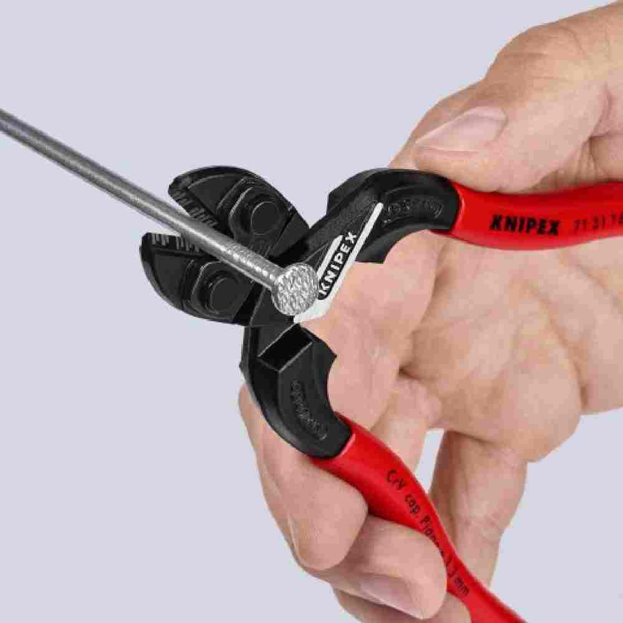 Knipex 7131160SBA 6-1/4 inch CoBolt Compact Bolt Cutter Notched Blade showing in use cutting a nail Knipex 7131160SBA 6-1/4 inch CoBolt Compact Bolt Cutter Notched Blade showing in use cutting a nail