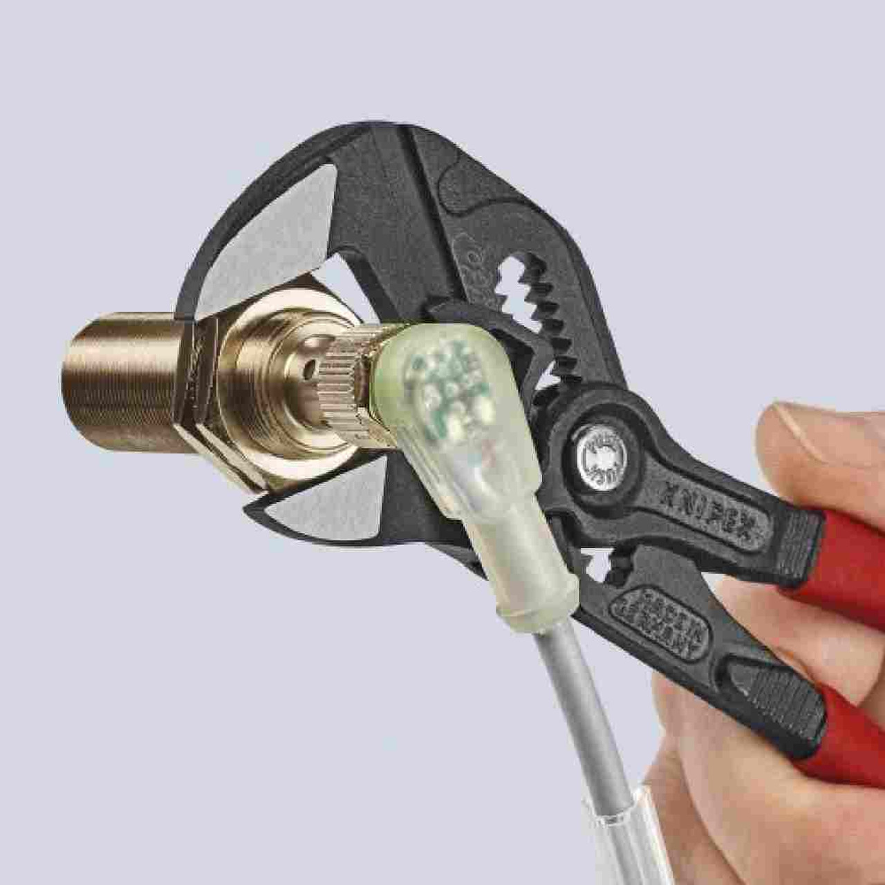 Knipex 8601180SBA 7-1/4 inch Adjustable Wrench Pliers Black showing in use tightening of a brass fitting Knipex 8601180SBA 7-1/4 inch Adjustable Wrench Pliers Black showing in use tightening of a brass fitting