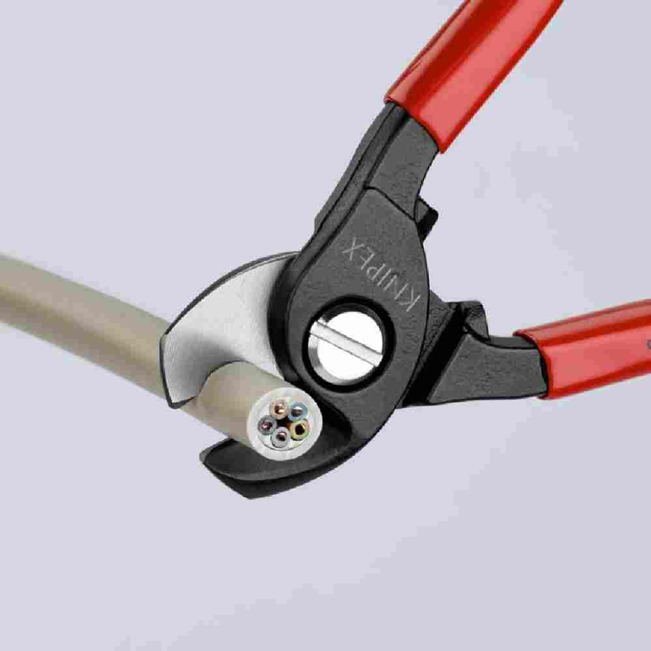 Knipex 9511165SBA 6-1/2 inch Cable Shears showing in use cutting cable Knipex 9511165SBA 6-1/2 inch Cable Shears showing in use cutting cable